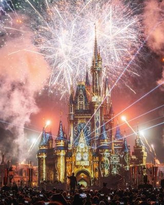 Stunning fireworks illuminate Cinderella Castle, creating a magical evening spectacle.