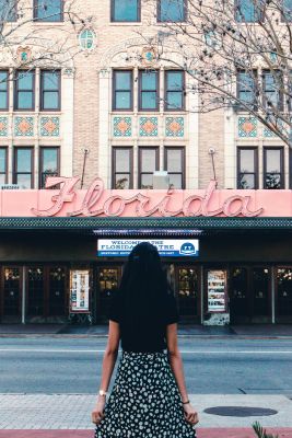 A woman in black stands outside the historic Florida Theatre, Jacksonville.